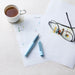 Green fountain pen on papers with glasses and tea cup for writing and planning
