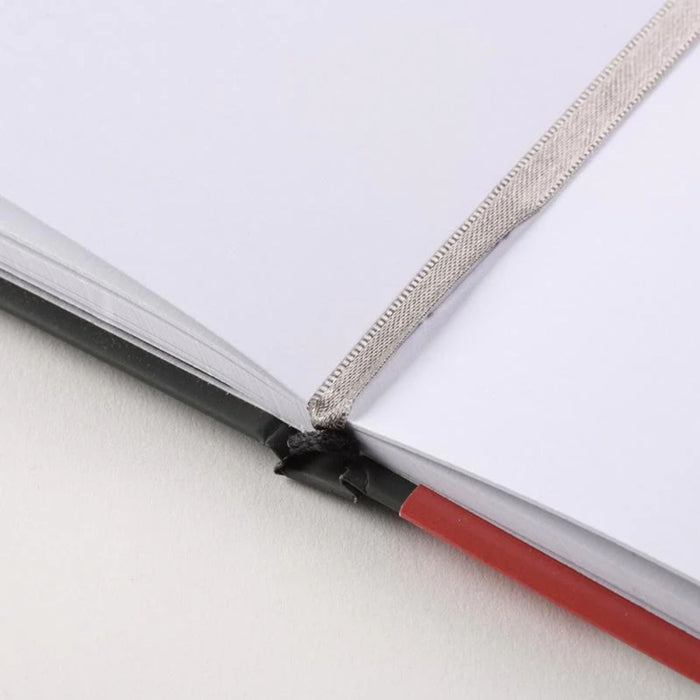 Close-up of Canson Graduate Manga Sketchbook lie-flat binding and bookmark ribbon