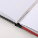 Close-up of Canson Graduate Manga Sketchbook lie-flat binding and bookmark ribbon