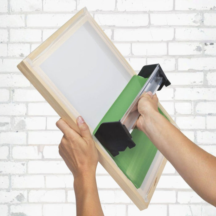 Speedball Scoop Coater applying green photo emulsion to a screen printing frame