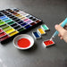 Kuretake Gansai Tambi watercolour palette with brush activating paint