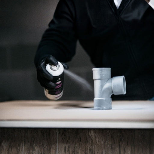 Applying MTN WEPRO Universal Primer spray to a non-absorbent surface before painting