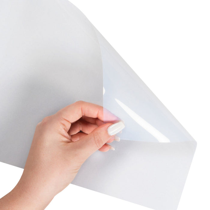 Clear inkjet transparency sheet being held to show flexible transparent film