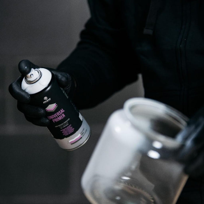 Close-up of MTN WEPRO Universal Primer aerosol can during surface preparation