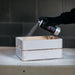 Spraying MTN WEPRO Universal Primer onto a wooden crate for improved paint adhesion