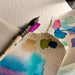 Close-up of Fabriano Artistico 100 percent cotton cold press watercolour paper texture with paint samples