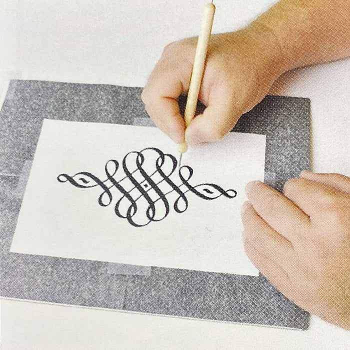 Tracing design onto surface using graphite transfer paper and stylus