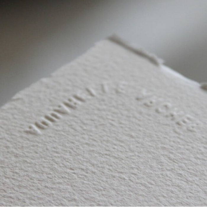 Close-up of Arches watercolour paper texture and embossed watermark detail