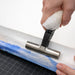 Using canvas pliers to stretch painting canvas on stretcher bars