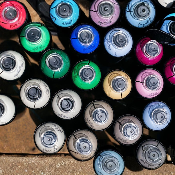 Top view of assorted MTN Hardcore spray paint cans showing colour identification rings