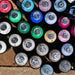 Top view of assorted MTN Hardcore spray paint cans showing colour identification rings