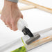 Artist pulling canvas tight with stretching pliers during framing