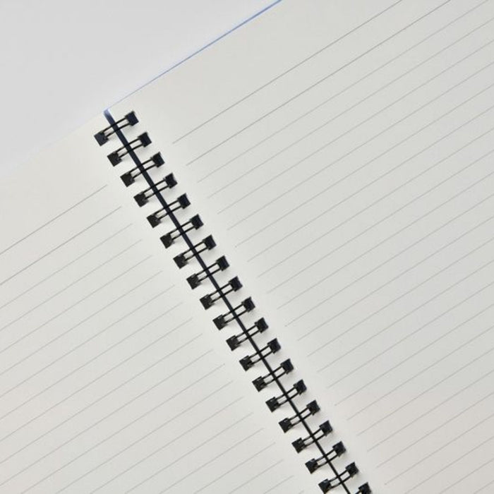 Close-up of lined paper and twin ring binding inside Apica CD Twin Ring Notebook