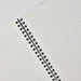 Close-up of lined paper and twin ring binding inside Apica CD Twin Ring Notebook