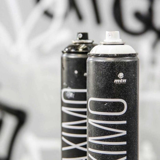Close-up of MTN Maximo 750ml spray paint cans showing professional aerosol paint nozzles