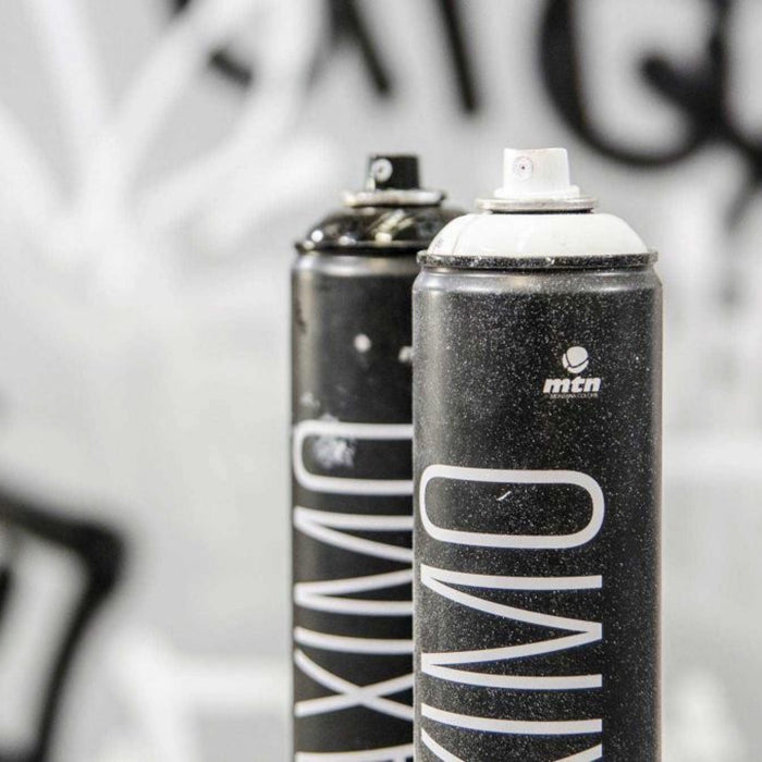 Close-up of MTN Maximo 750ml spray paint cans showing professional aerosol paint nozzles